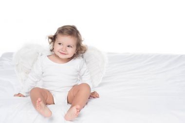 gülümseyen bebek yatak, üzerinde beyaz izole oturan kanatlı