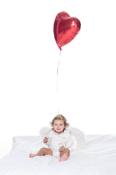baby angel with wings and nimbus holding heart balloon, isolated on white