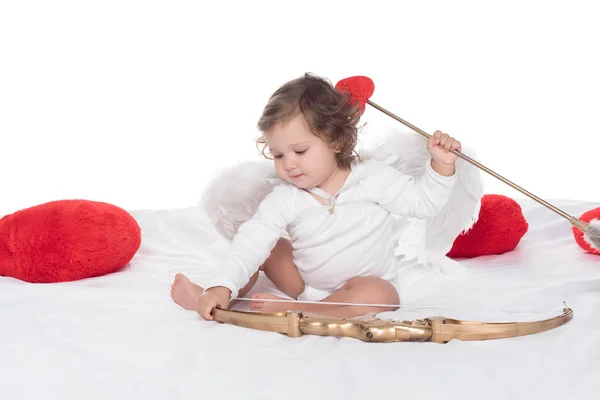 小天使坐在床上弓和箭 孤立的白色 — 图库照片