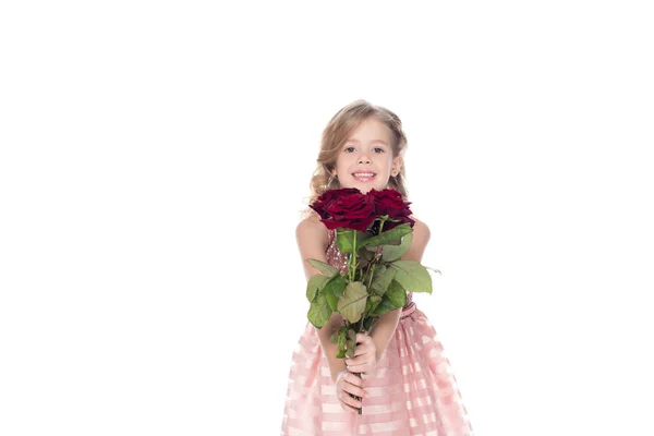 微笑的孩子在礼服捧着花束的红玫瑰 孤立的白色 — 免费的图库照片