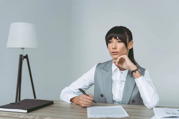 Thoughtful Businesswoman Signing Contract Isolated Gray — Free Stock Photo