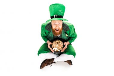 excited leprechaun in green suit holding pot of gold, isolated on white  clipart