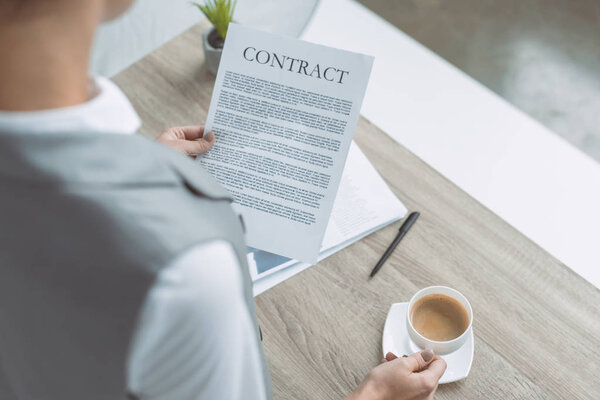 cropped image of businesswoman reading contract