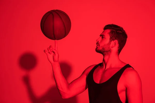 Deportista Muscular Sosteniendo Pelota Baloncesto Dedo Contraste Luz Roja — Foto de Stock