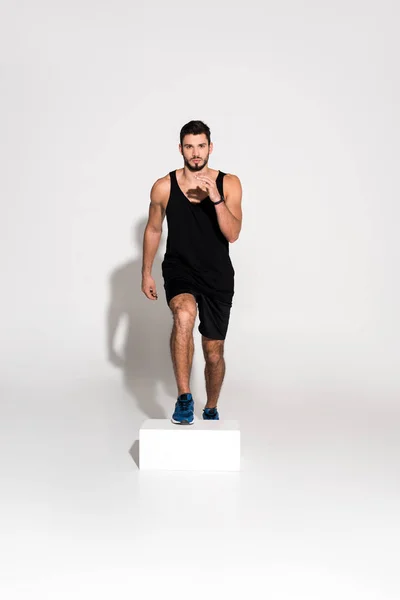 Handsome Young Man Doing Step Aerobics Block — Stock Photo, Image