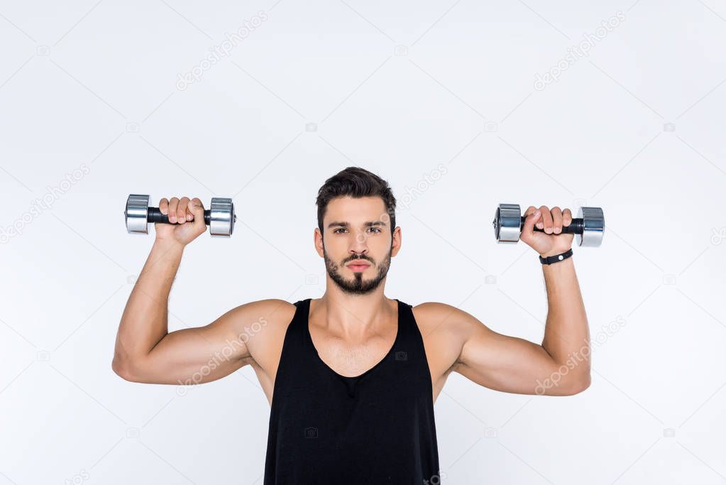 handsome young man working out with dumbbells isolated on white