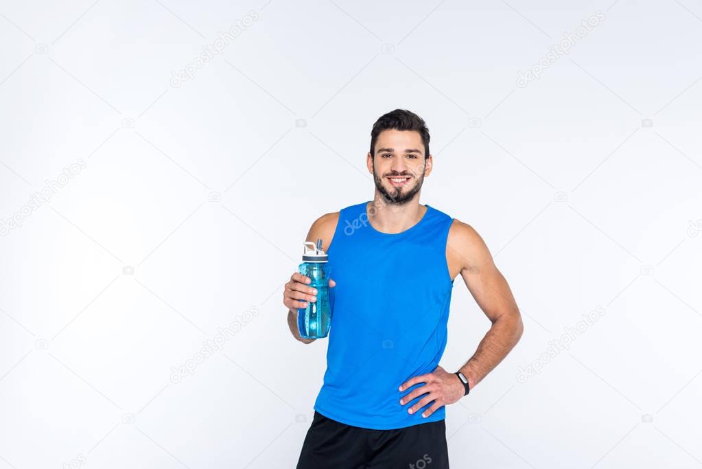 smiling young man with fitness bottle isolated on white
