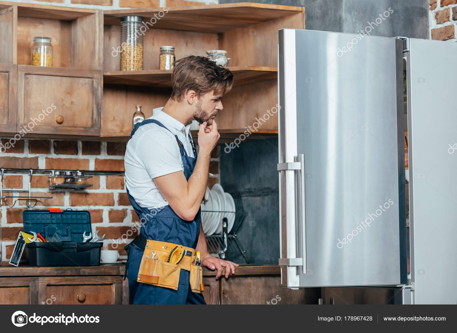 Young Repairman Tool Belt Looking Broken Refrigerator — Stock Photo
