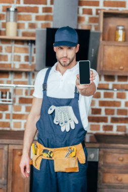 yakışıklı genç profesyonel ev master Smartphone boş ekran ile gösterilen
