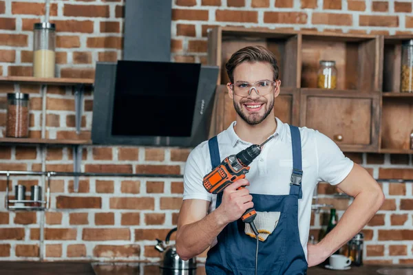 Pohledný Mladý Muž Držící Elektrickou Vrtačku Usmívá Kameru — Stock fotografie