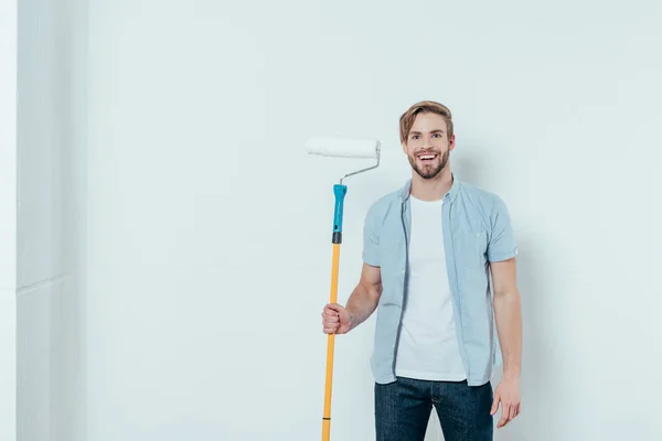 Handsome Young Man Holding Paint Roller Smiling Camera Grey — Stock Photo, Image