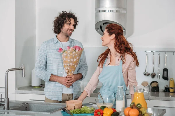 Boyfriend Presenting Bouquet Tulips Girlfriend Kitchen — Stock Photo, Image