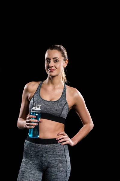 Young Sportswoman Holding Bottle Water Looking Camera Isolated Black — Stock Photo, Image