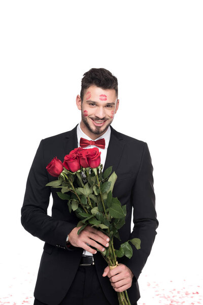 man with lips traces on face holding bouquet of roses isolated on white, valentines day concept