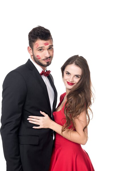 girlfriend hugging boyfriend with lips traces on face isolated on white