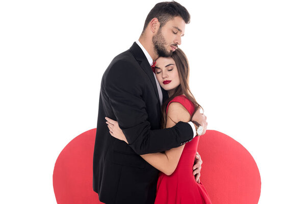 couple hugging near big heart isolated on white, valentines day concept