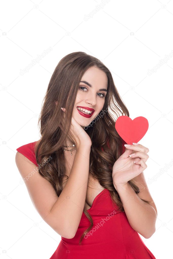 smiling girl in red dress holding paper heart isolated on white, valentines day concept