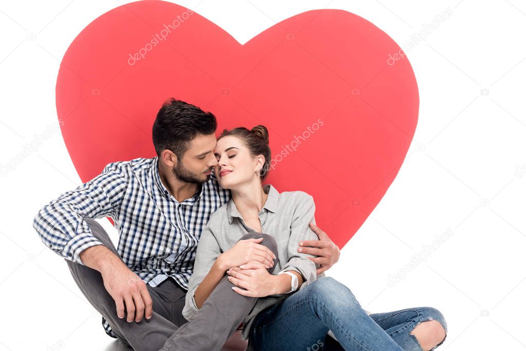 couple going to kiss near big heart isolated on white, valentines day concept