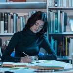 Student studying in library at late evening