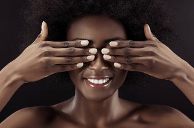 beautiful african american woman covering eyes with hands isolated on black