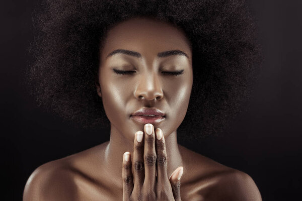 beautiful african american woman with closed eyes isolated on black