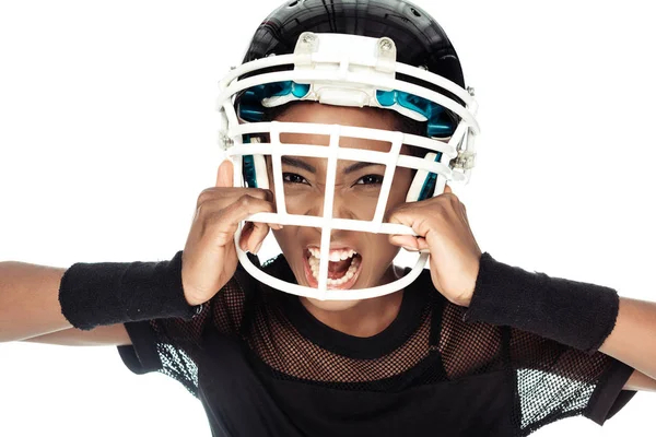积极的女性美国足球运动员的高角度的看法 试图脱下她的头盔在白色隔离 — 免费的图库照片