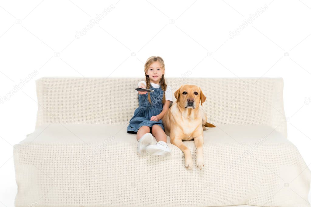 child and dog watching tv on sofa, isolated on white
