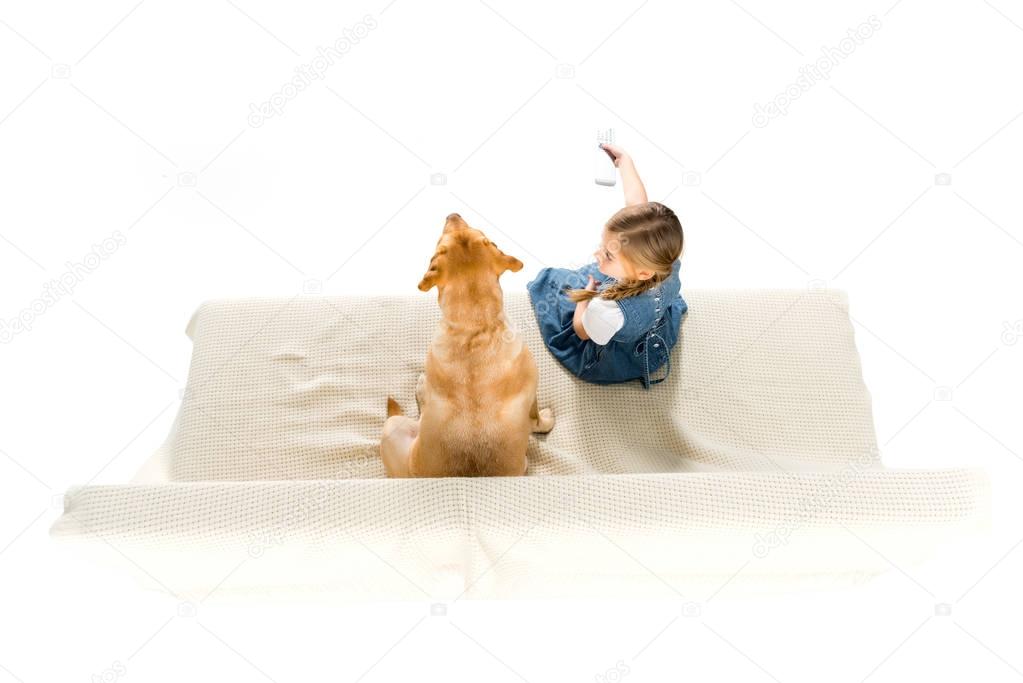 overhead view of child and dog watching tv on sofa, isolated on white