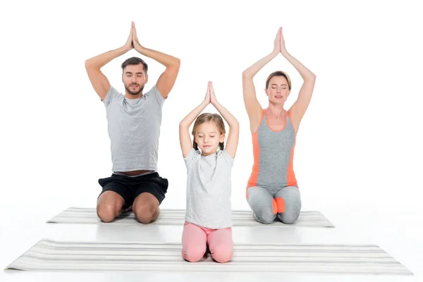 Athletic family practicing yoga on mats together isolated on white — Stock Image Athletic Family Practicing Yoga Mats Together Isolated White Royalty Free Stock Photos