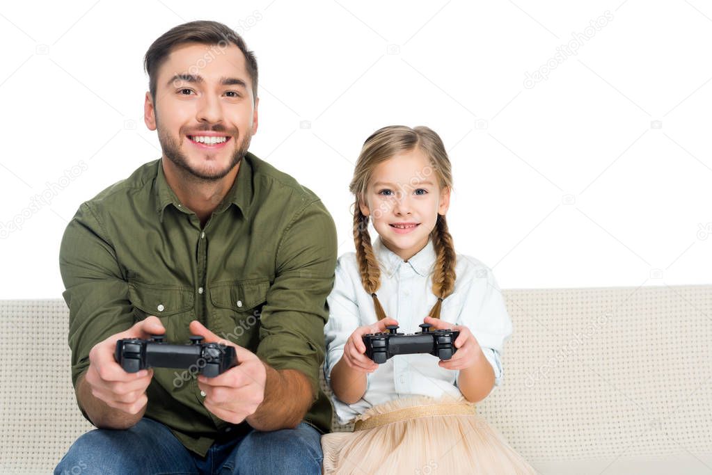 smiling father and daughter playing video game together isolated on white