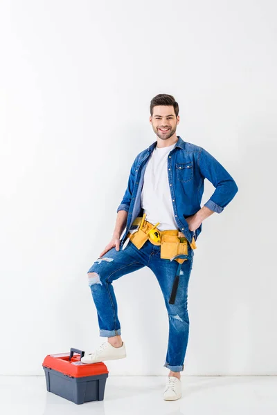 Smiling worker putting leg on tools box and looking at camera — Stock Image Smiling Worker Putting Leg Tools Box Looking Camera Stock Image