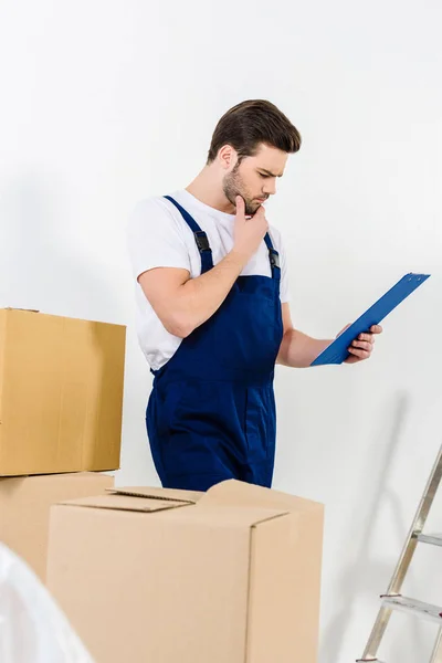 Thoughtful Relocation Service Worker Looking Clipboard — Free Stock Photo