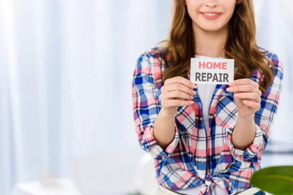 Cropped image of smiling girl holding home repair card — Stock Image Cropped Image Smiling Girl Holding Home Repair Card Stock Photo