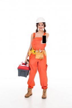 Araç kutusu ve smartphone, üzerinde beyaz izole tutan üniformalı güzel gülümseyen workwoman