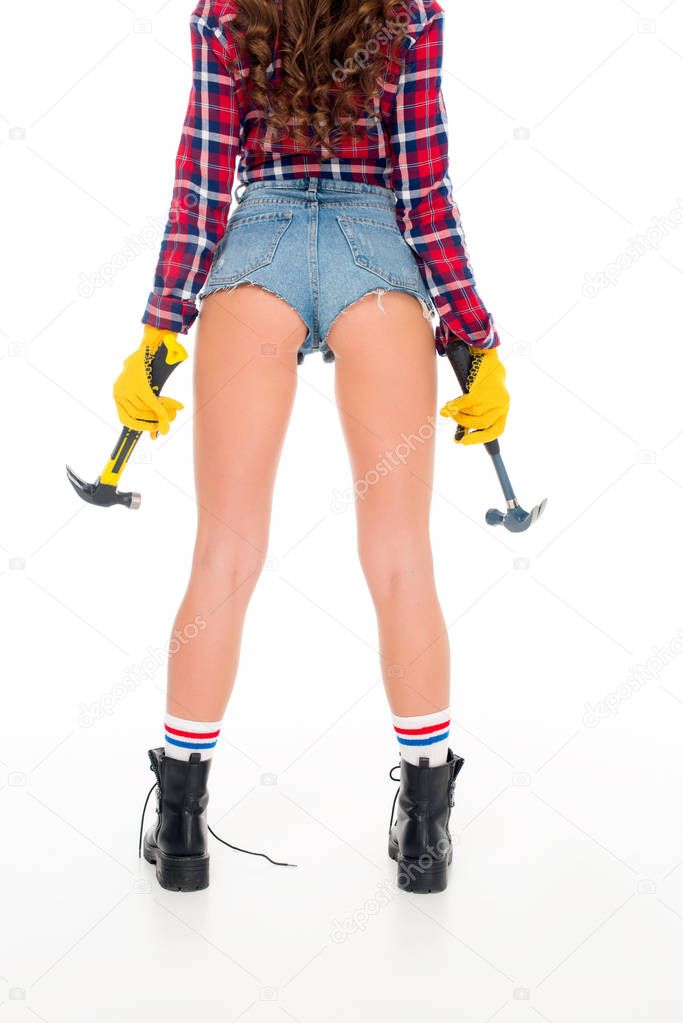 back cropped view of sexy girl with hammers, isolated on white