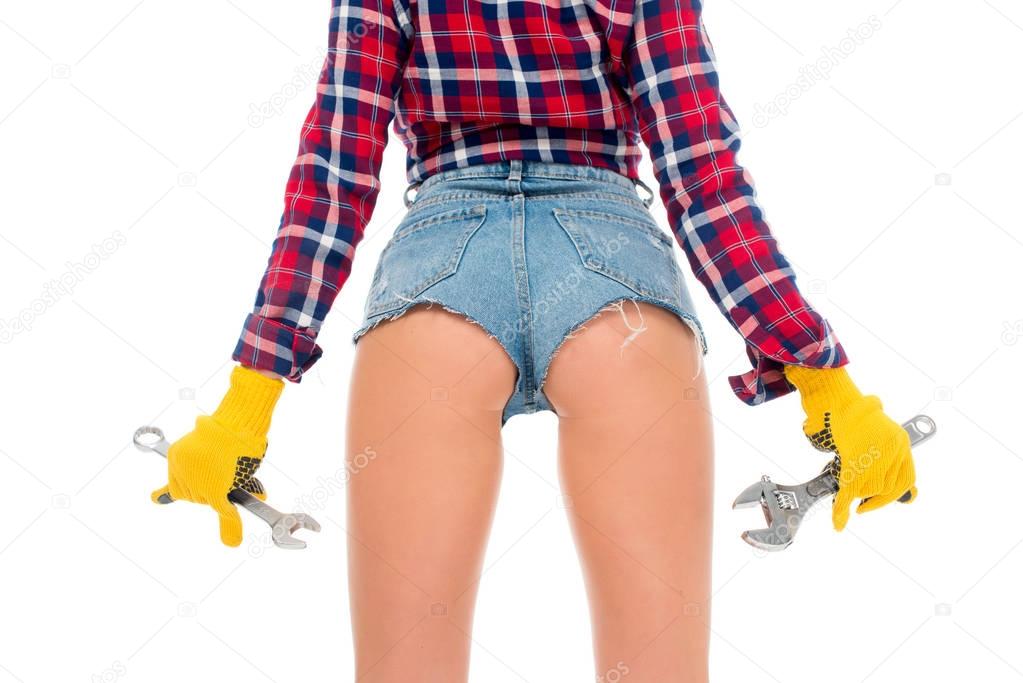 back cropped view of sexy girl with wrenches, isolated on white