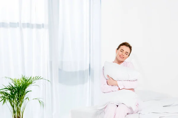 Happy Woman Embracing Pillow While Sitting Bed Morning — Stock Photo, Image