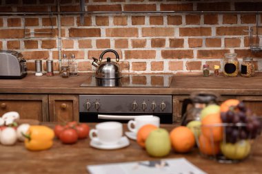 electric stove and kettle in modern kitchen clipart