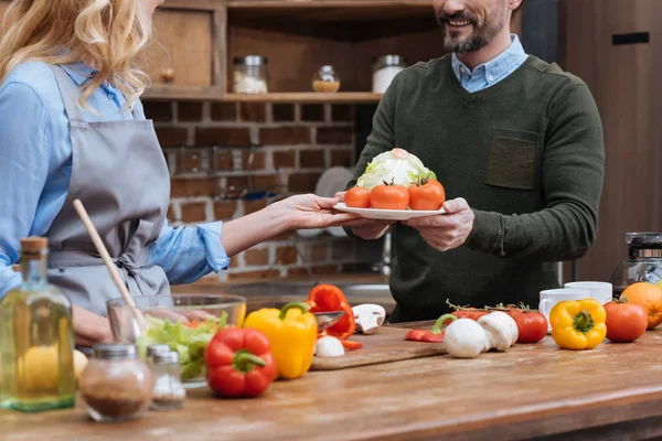Cropped Image Wife Giving Plate Vegetables Husband — Stock Photo, Image