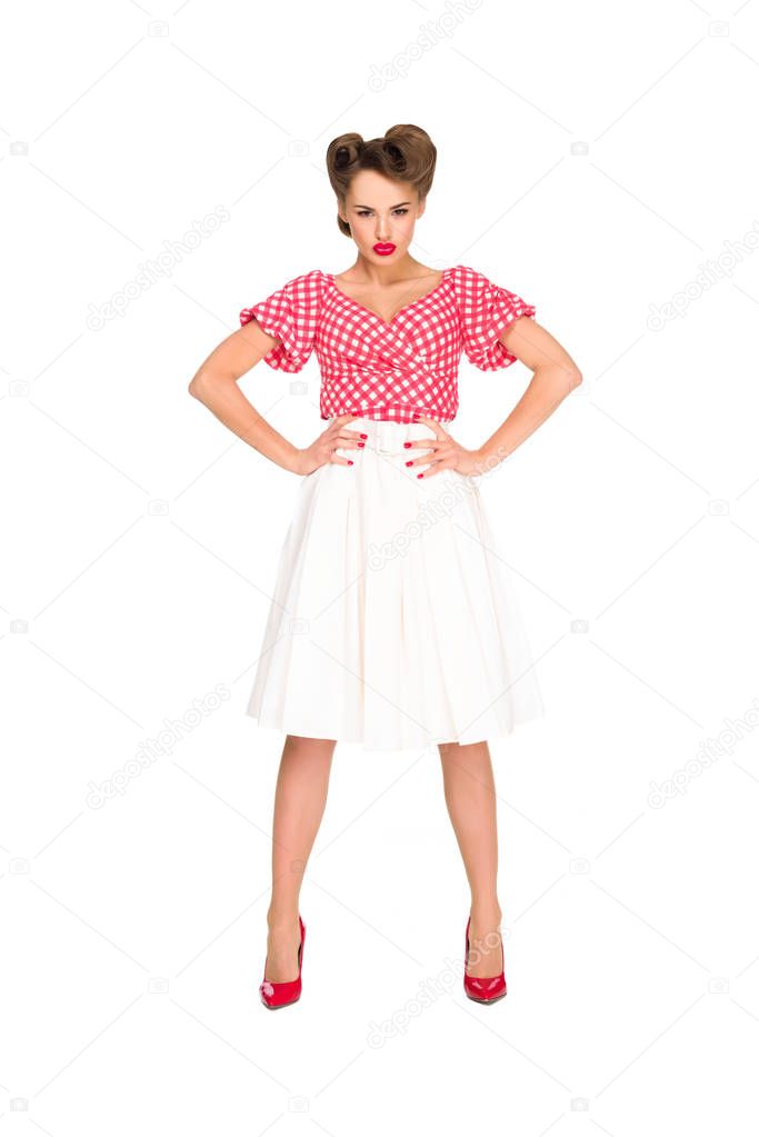 young woman in retro style clothing standing akimbo isolated on white