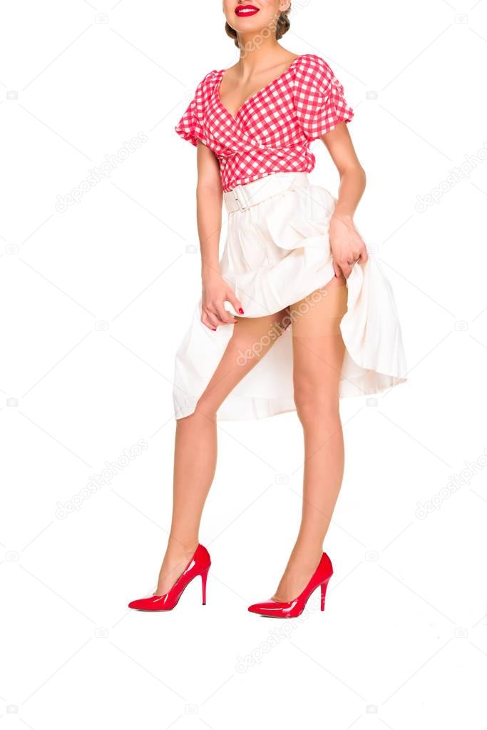 cropped shot of woman in red high heels and skirt isolated on white