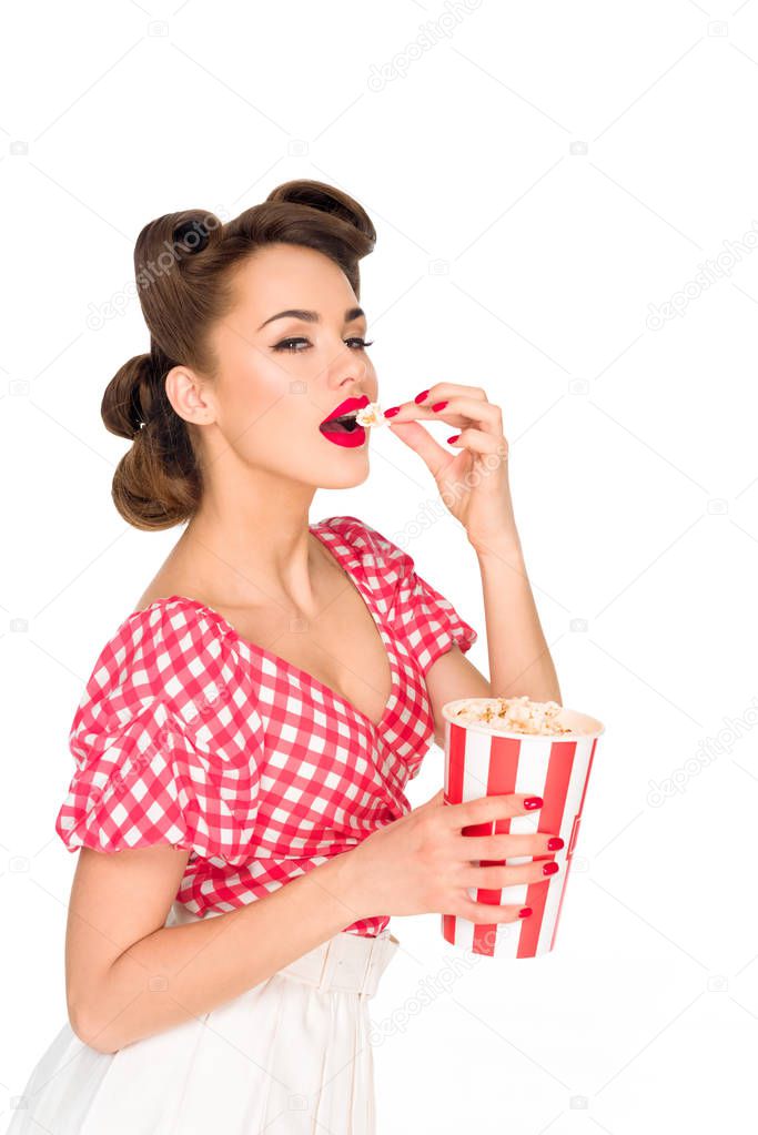 portrait of stylish young woman eating popcorn isolated on white