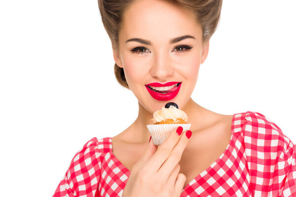 portrait of beautiful woman in pin up clothing with cupcake isolated on white