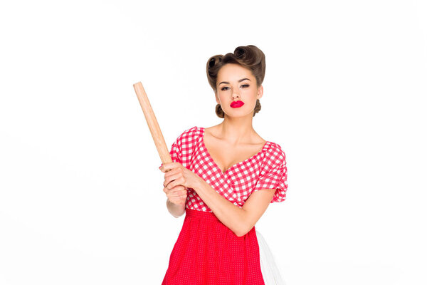 portrait of stylish woman in retro clothing and apron with rolling pin isolated on white