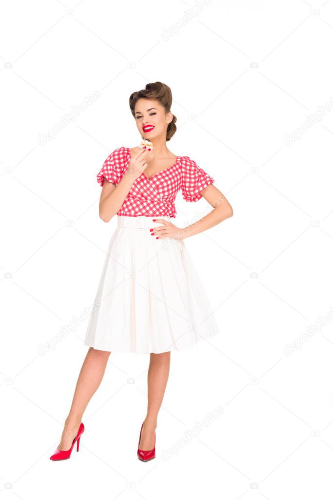 beautiful smiling woman in pin up clothing with cupcake isolated on white