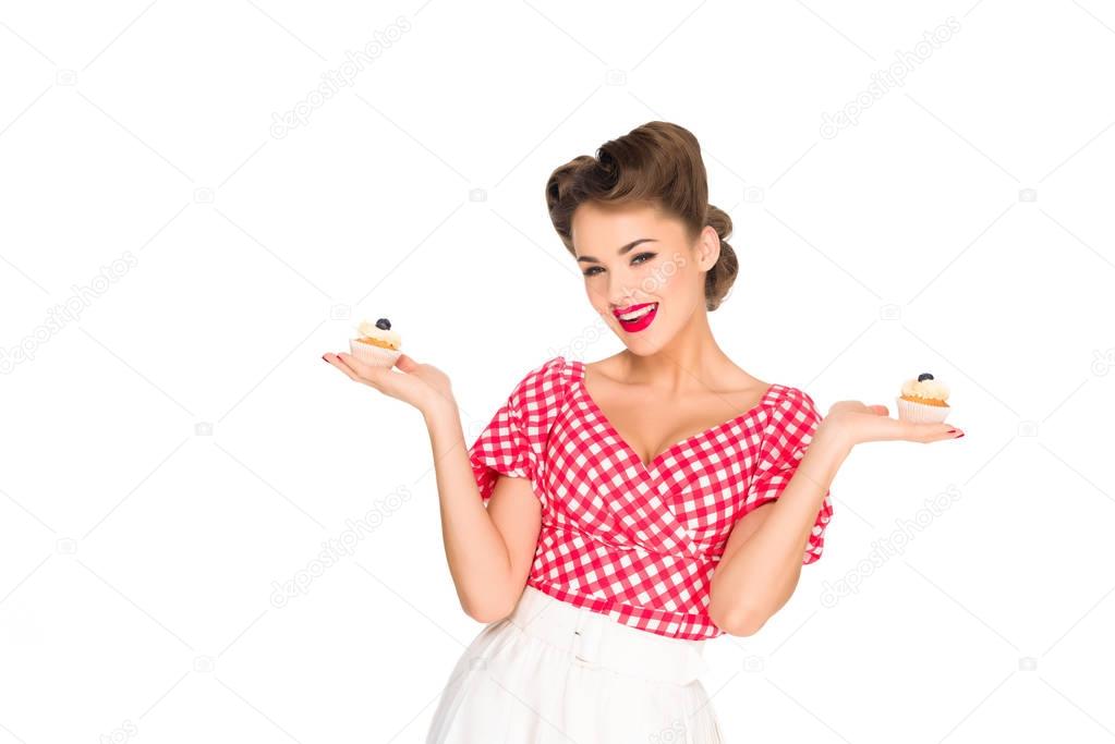 portrait of beautiful woman in pin up clothing with cupcakes isolated on white