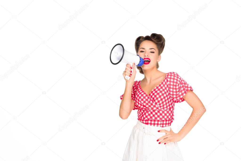 portrait of fashionable young woman in pin up style clothing with loudspeaker isolated on white