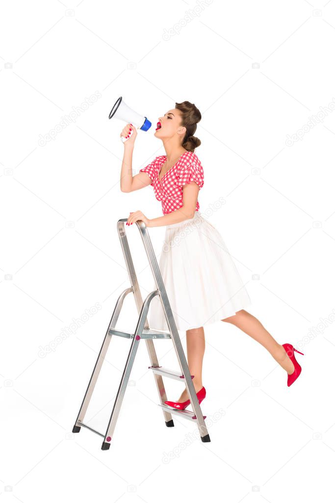 pin up woman with loudspeaker standing on ladder isolated on white