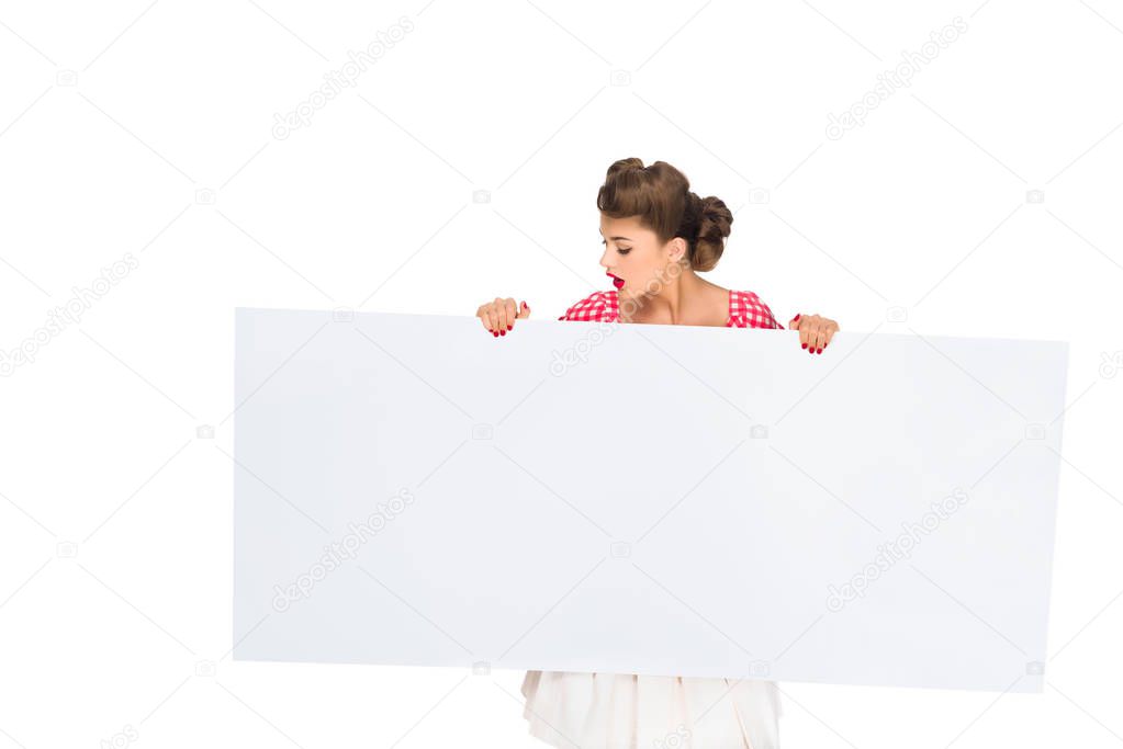 stylish woman looking at blank banner in hands isolated on white