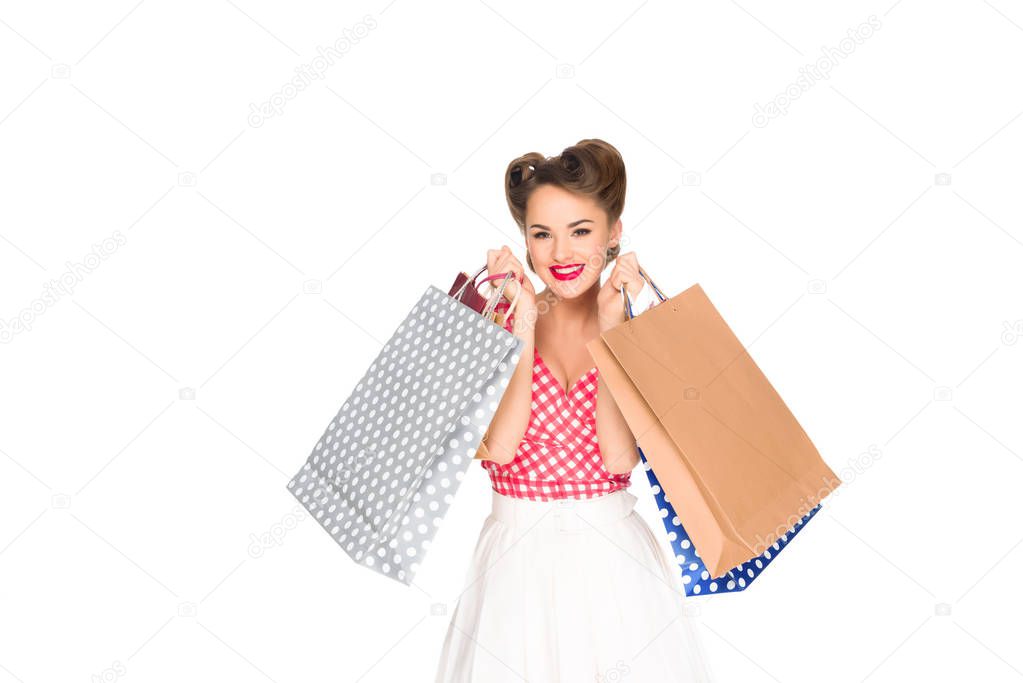 smiling woman in retro style clothing with shopping bags isolated on white